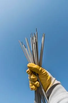 Welding electrodes in the hands of the worker Stock Photos