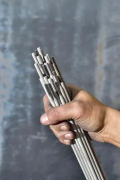 Welding electrodes in the hands of the worker Stock Photos