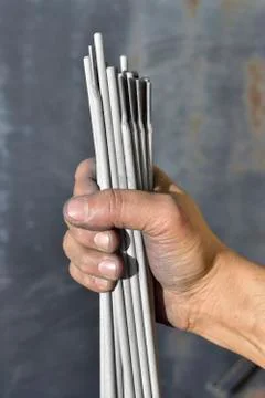 Welding electrodes in the hands of the worker Stock Photos