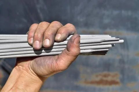 Welding electrodes in the hands of the worker Stock-Fotos
