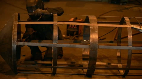 Welding Engineer completes the weld cell skeleton of metal tanks. lot of bright Stock Footage 57513623