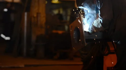 Welding Engineer weld attaching the base of pipes.a lot of sparks, smoke and Stock Footage 57513529