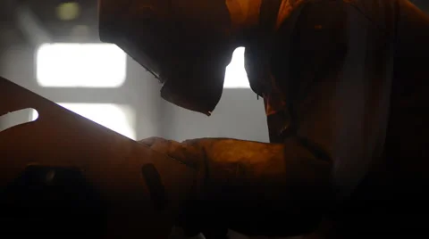 Welding Engineer weld metal. bright sparks, smoke and light. Construction and Stock Footage 57513594