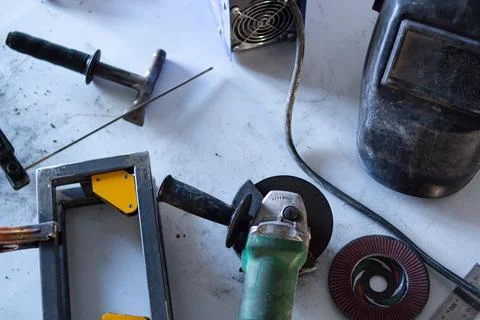 Welding equipment, on the table, various hand tools are laid out around Stock Photos