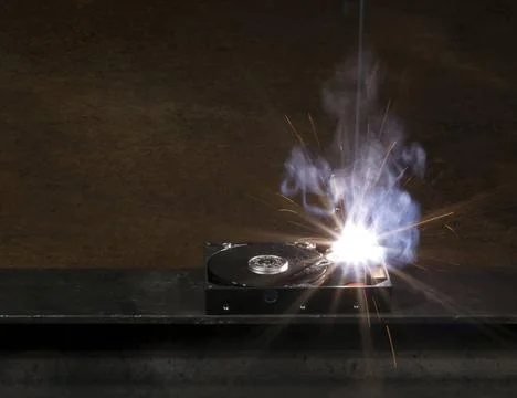 Welding a hard disk welding scenery with hard disk drive, welding mask det... Stock Photos