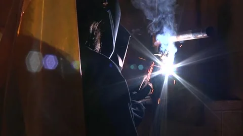 Welding instructor with student using arc welder Stock Footage 56435719