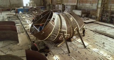 Welding a large pipe in a metalworking shop. Huge workshop for assembling steel Stock Footage 313938109