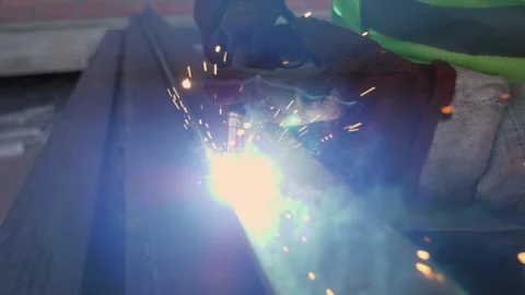 Welding machine, bright sparks and flashes in super slow motion. Close-up. Video stock 230979994