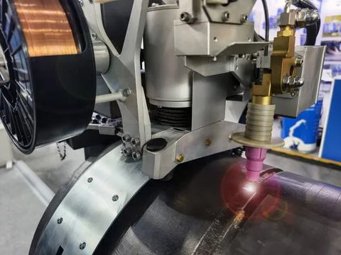 Welding machine performs task on metal surface at industrial facility in wo.. Stock Photos