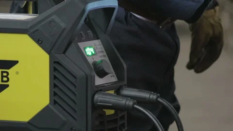 Welding machine in process of work with lights of welding and welder near Stock Footage 88058307