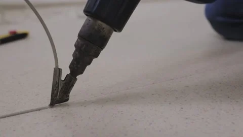 Welding machine type construction dryer solders pieces of linoleum welding cord Stock Footage 147174320