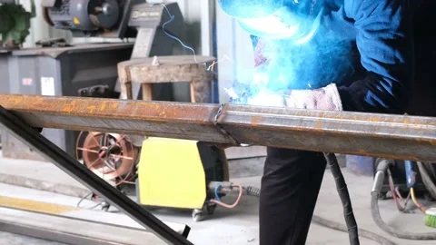Welding machine, welder is welding with welding machine, in workshop Stock Footage 163891141