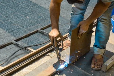 Welding man at work in the rolling shutter factory Stock Photos