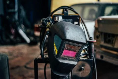 Welding mask on garage workshop background Stock-Fotos
