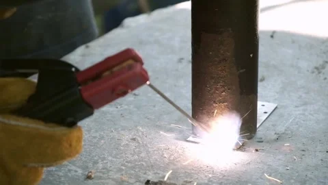 Welding metal pipe on steel surface, intense light and heat. Industrial work Stock Footage 319029174