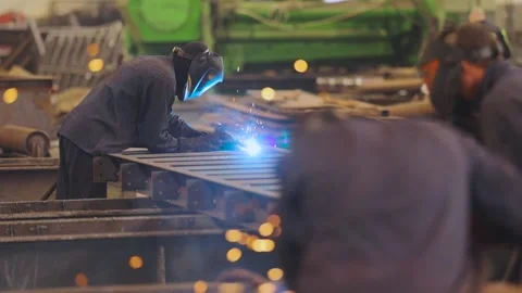 Welding a metal structure in a factory. Two welders weld a metal part. Stock-Footage 155063019