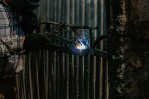 Welding metal structures at a construction site, welding a metal frame for fu Stock Photos