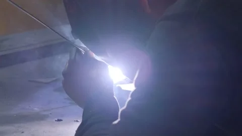 Welding of metal structures. A worker in a protective mask welds metal. Stock Footage 260623891
