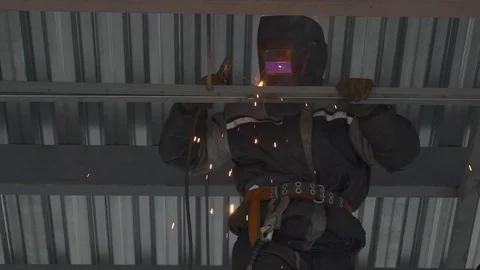 Welding of metal structures. Worker welding structural elements, sparks. Stock Footage 73029666