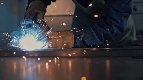 Welding metal with a welding machine by a welder in a welding shop. C Stock Footage 265510258