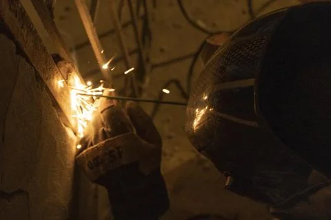 Welding the old gate in a underground Stockfoto's