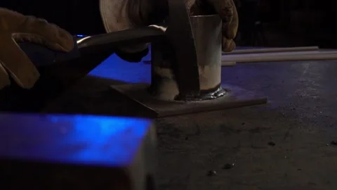 Welding Pick Removing Slag in a Workshop. Profile angle. Slow Motion Stock Footage 254745149