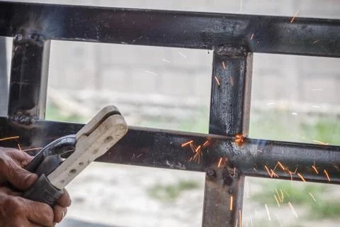 Welding Process with black block metal and bright sparks in steel Stock Photos