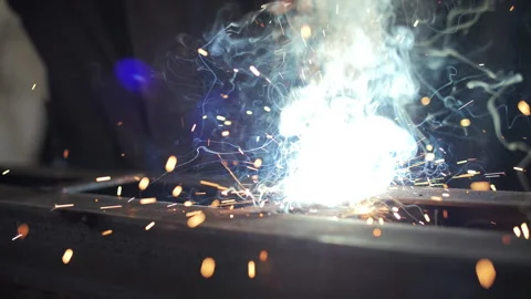 Welding process with bright sparks and smoke Stock Footage 318383349