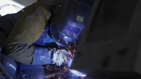 Welding process at factory sparks fly as metal is fused together Stock Footage 314057423