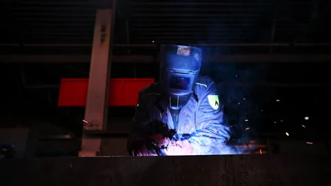 Welding Process in Industrial Setting is characterized by intense Sparks and Stock Footage 310314265