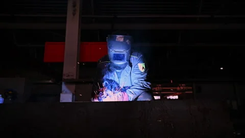 Welding Process in Industrial Setting is characterized by intense Sparks and Stock Footage 310339589