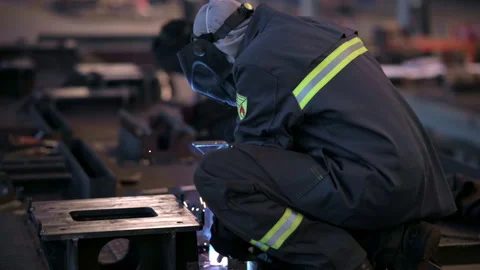 Welding Process in Industrial Setting is characterized by intense Sparks and Stock Footage 310950135