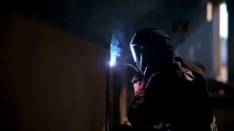 Welding Process in Industrial Setting is characterized by intense Sparks and Stock Footage 310956284