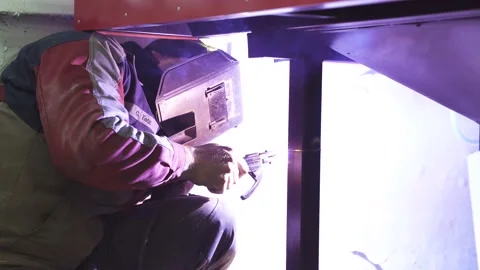 Welding process with sparks and flashes. Melat welder in safety equipment Stock-Footage 164548829