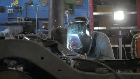 Welding process. Welder in helmet works, worker works in the auto workshop. Video stock 139287807