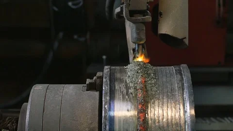 Welding robots apply overlay weld protection on the pipe disks. Automatic Stock Footage 84833268