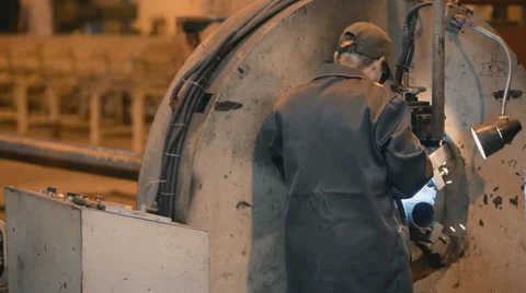 Welding robots movement in a weld factors for the creation of pipes. engineer at Stock Footage 57513422