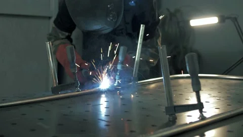 Welding with a semi-automatic welder is accompanied by a lot of flying sparks Stock Footage 179700949
