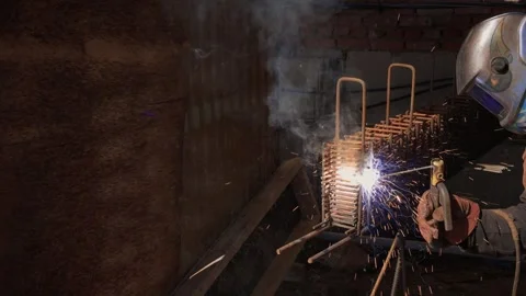 Welding Sparks Are Flying High as Metalwork Beautifully Takes Shape in the Stock Footage 309891141