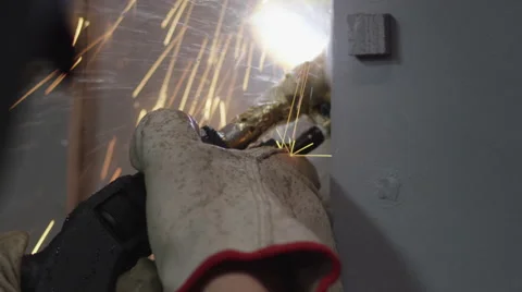 Welding sparks falling out while a worker welding the metal door Stock Footage 67554094