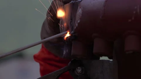 Welding. Welding beam, stick, Close-up. Metallic red object. Bright flash from Stock Footage 165105506