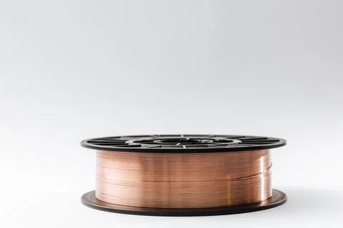 Welding wire on a spool on a white background, copy space Stock Photos