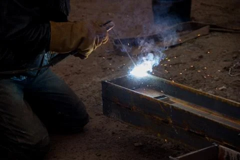 Welding work at a construction site. The construction of a metal frame. Stock Photos