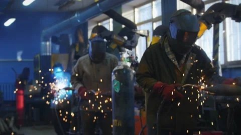 Welding work at the factory. Workers are engaged in gas welding. Factory work. Stock Footage 218026349