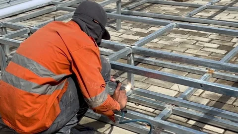 Welding work of thin hollow iron close up Stock Footage 296723945