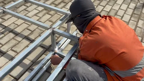 Welding work of thin hollow iron close up Stock Footage 296724064