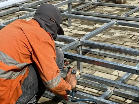 Welding work of thin hollow iron close up Stock Photos