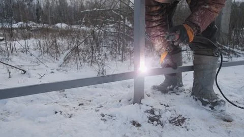 Welding work when installing a metal fence Foto stock
