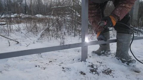 Welding work when installing a metal fence Stock-Fotos