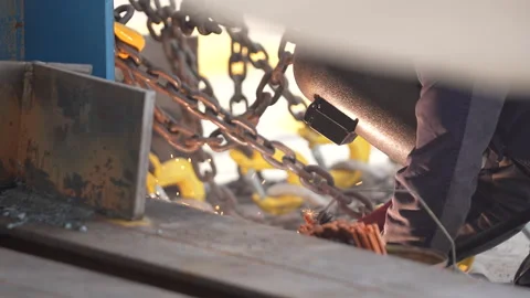 Welding work. A worker welds chains at a factory Video stock 285962024